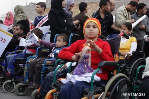 Palestinians and physically challenged people take part in a rally marking the International Day of Persons with Disabilities in Gaza City on Dec. 04, 2013. According to a United Nations report on disabilities, physical,...