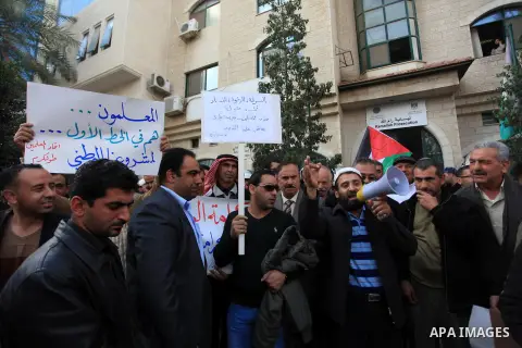 Palestinian teachers shout slogans during a demonstration outside the court, in the West Bank City of Ramallah, Dec. 04, 2013. The Union organized regular strikes in the first half of 2013 to protest unpaid salaries. It...