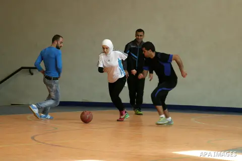 Abir Harb, a 18 year-old Palestinian referee, demonstrates her skills at the stadium of An-Najah national University, in the West Bank City of Nablus, Dec. 04, 2013. Harb is a student in the faculty of sport education an...