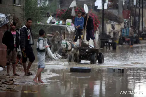 A Palestinian man rides his cart in a flooded street after a torrential rains Gaza city, on Dec. 05, 2013. Photo by Ashraf Amra