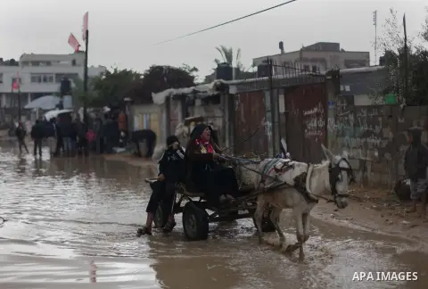 A Palestinian man rides his cart in a flooded street after a torrential rains Gaza city, on Dec. 05, 2013. Photo by Ashraf Amra