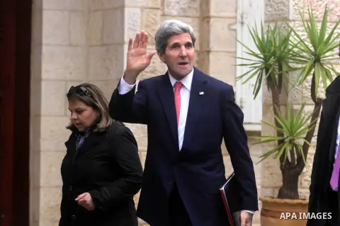 U.S. Secretary of State John Kerry waves upon arrival for a meeting with Palestinian President Mahmoud Abbas in the West Bank city of Ramallah on Thursday, Dec. 5, 2013. Kerry said, when he met with Israeli Prime Ministe...