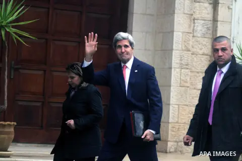 U.S. Secretary of State John Kerry waves upon arrival for a meeting with Palestinian President Mahmoud Abbas in the West Bank city of Ramallah on Thursday, Dec. 5, 2013. Kerry said, when he met with Israeli Prime Ministe...