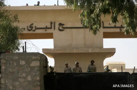 Egyptian soldiers look on from behind the gate of the Rafah border crossing point during a demonstration held by Palestinian doctors and patients on December 5, 2013, demanding the permanent and unconditional opening of...