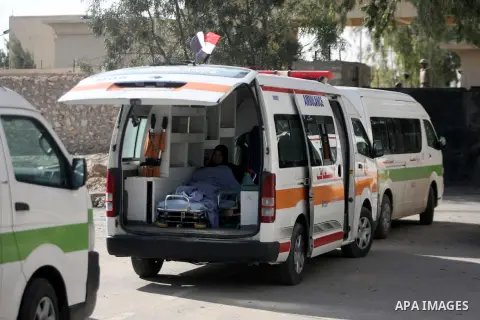 Ambulances are parked at the gate of the Rafah border crossing point, on December 5, 2013, as Egyptian soldiers look on during a demonstration held by Palestinian doctors and patients demanding the permanent and uncondit...