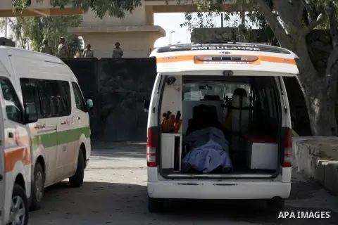 Ambulances are parked at the gate of the Rafah border crossing point, on December 5, 2013, as Egyptian soldiers look on during a demonstration held by Palestinian doctors and patients demanding the permanent and uncondit...