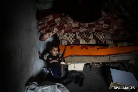 A Palestinian girl plays at her family's house during a heavy raining day in Beit Lahiya, northern Gaza Strip, Thursday, Dec. 5, 2013. Heavy rains flooded most streets and blocked some of the streets of the refugee camps...