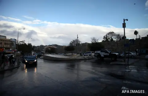 Palestinians walk at a street during a rainy day in Jerusalem's Old City, Dec. 05, 2013. Photo by Saeed Qaq