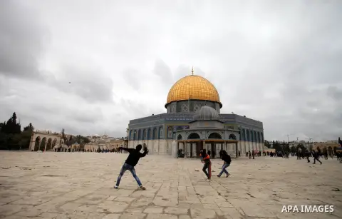 Palestinian protesters throw stones towards Israeli riot police during clashes following Friday prayers at Jerusalem's al-Aqsa mosque compound, on December 6, 2013. Israeli police hurled stun grenades to disperse stone-t...