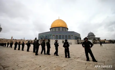 Israeli riot police stand in the grounds of Jerusalem's al-Aqsa mosque compound during clashes with Palestinian stone-throwers following Friday prayers, on December 6, 2013. Israeli police hurled stun grenades to dispers...