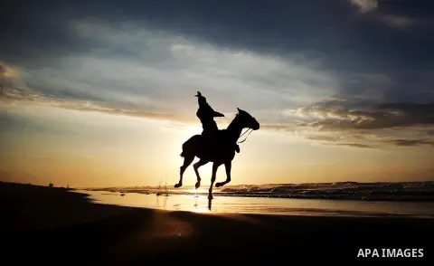 A Palestinian man rides a horse during the sunset on the beach of Gaza City, Dec. 06, 2013. British human rights organization Amnesty International condemned the Israeli blockade on the Gaza Strip in a statement released...