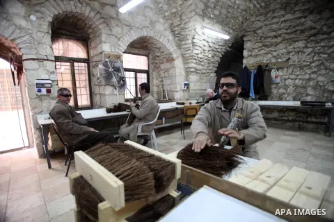 Palestinian blind men work in making brooms at a workshop in the Old City of Jerusalem on Dec. 07, 2013. The workshop is owned and managed by the Arab Blind Association, which was founded by blind Palestinians in 1932, a...