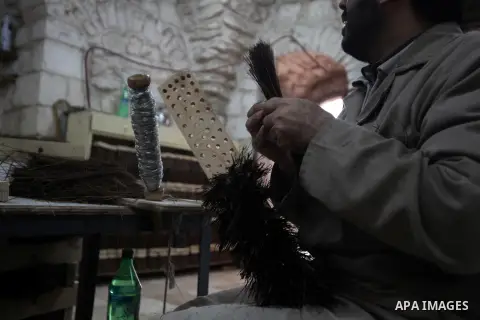 A Palestinian blind man works in making brooms at a workshop in the Old City of Jerusalem on Dec. 07, 2013. The workshop is owned and managed by the Arab Blind Association, which was founded by blind Palestinians in 1932...