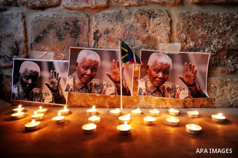 Palestinians gather at a candle memorial for late South African President Nelson Mandela in an area of Jerusalem's Old City popular to Africans, 07 December 2013. Nobel Peace Prize winner Nelson Mandela died at age 95, i...