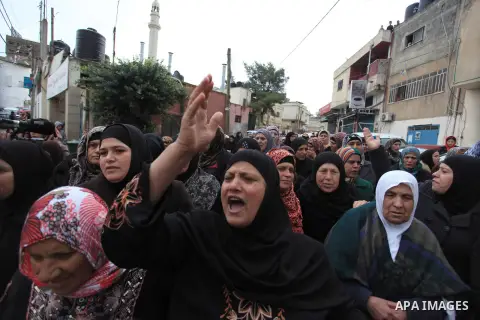 Female mourners grieve during the funeral of 15-year-old Palestinian Waji al-Ramhi in the Jelazoun refugee camp in the West Bank city of Ramallah on December 8, 2013. Israeli troops shot dead Ramhi during early evening c...