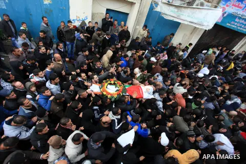 Mourners carry the body of 15-year-old Palestinian Waji al-Ramhi during his funeral in the Jelazoun refugee camp in the West Bank city of Ramallah on December 8, 2013. Israeli troops shot dead Ramhi during early evening...
