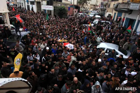 Mourners carry the body of 15-year-old Palestinian Waji al-Ramhi during his funeral in the Jelazoun refugee camp in the West Bank city of Ramallah on December 8, 2013. Israeli troops shot dead Ramhi during early evening...