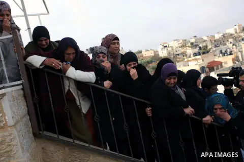 Female mourners grieve during the funeral of 15-year-old Palestinian Waji al-Ramhi in the Jelazoun refugee camp in the West Bank city of Ramallah on December 8, 2013. Israeli troops shot dead Ramhi during early evening c...
