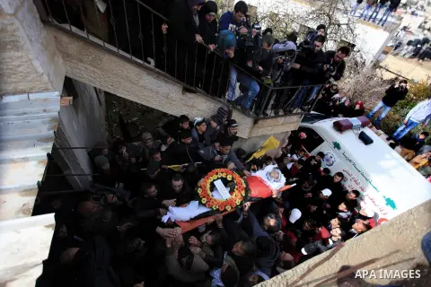Mourners carry the body of 15-year-old Palestinian Waji al-Ramhi during his funeral in the Jelazoun refugee camp in the West Bank city of Ramallah on December 8, 2013. Israeli troops shot dead Ramhi during early evening...