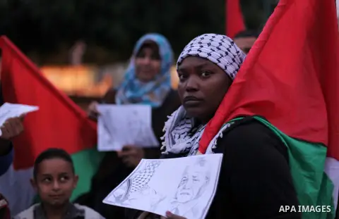 Palestinians hold portraits of late South African leader Nelson Mandela, during a candle vigil in Gaza City on December 8, 2013. Mandela, the revered icon of the anti-apartheid struggle in South Africa and one of the tow...