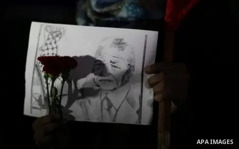 Palestinians hold portraits of late South African leader Nelson Mandela, during a candle vigil in Gaza City on December 8, 2013. Mandela, the revered icon of the anti-apartheid struggle in South Africa and one of the tow...