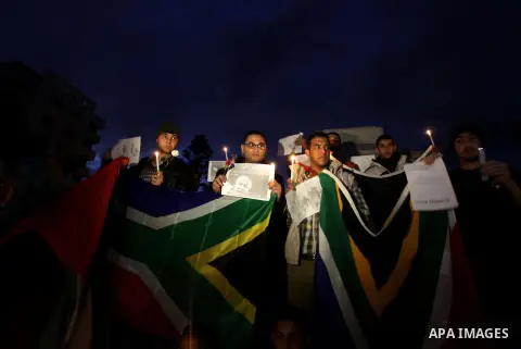 Palestinians hold portraits of late South African leader Nelson Mandela, during a candle vigil in Gaza City on December 8, 2013. Mandela, the revered icon of the anti-apartheid struggle in South Africa and one of the tow...
