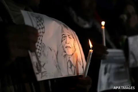 Palestinians hold portraits of late South African leader Nelson Mandela, during a candle vigil in Gaza City on December 8, 2013. Mandela, the revered icon of the anti-apartheid struggle in South Africa and one of the tow...