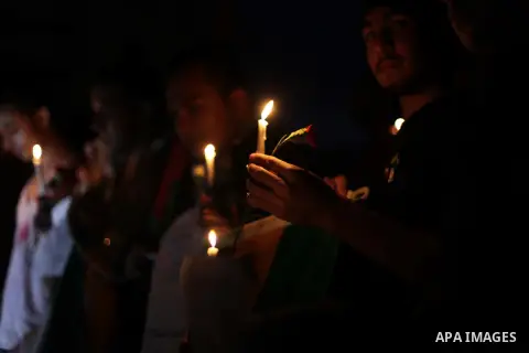 Palestinians hold portraits of late South African leader Nelson Mandela, during a candle vigil in Gaza City on December 8, 2013. Mandela, the revered icon of the anti-apartheid struggle in South Africa and one of the tow...