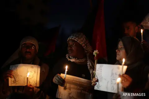 Palestinians hold portraits of late South African leader Nelson Mandela, during a candle vigil in Gaza City on December 8, 2013. Mandela, the revered icon of the anti-apartheid struggle in South Africa and one of the tow...