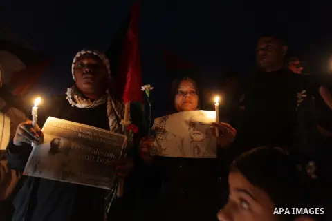Palestinians hold portraits of late South African leader Nelson Mandela, during a candle vigil in Gaza City on December 8, 2013. Mandela, the revered icon of the anti-apartheid struggle in South Africa and one of the tow...