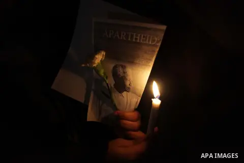 Palestinians hold portraits of late South African leader Nelson Mandela, during a candle vigil in Gaza City on December 8, 2013. Mandela, the revered icon of the anti-apartheid struggle in South Africa and one of the tow...