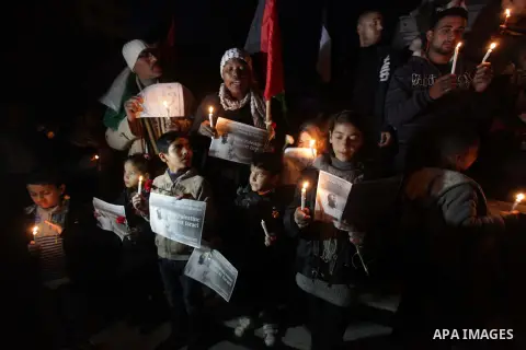 Palestinians hold portraits of late South African leader Nelson Mandela, during a candle vigil in Gaza City on December 8, 2013. Mandela, the revered icon of the anti-apartheid struggle in South Africa and one of the tow...