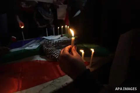 Palestinians put candles on a giant South African flag in the memory of late South African leader Nelson Mandela, during a candle vigil in Gaza City on December 8, 2013. Mandela, the revered icon of the anti-apartheid st...