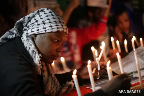 Palestinians put candles on a giant South African flag in the memory of late South African leader Nelson Mandela, during a candle vigil in Gaza City on December 8, 2013. Mandela, the revered icon of the anti-apartheid st...