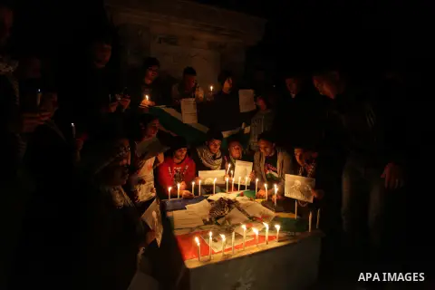 Palestinians hold portraits of late South African leader Nelson Mandela, during a candle vigil in Gaza City on December 8, 2013. Mandela, the revered icon of the anti-apartheid struggle in South Africa and one of the tow...