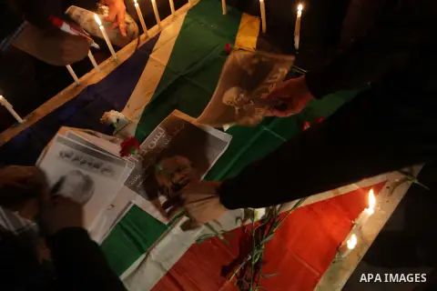 Palestinians put candles on a giant South African flag in the memory of late South African leader Nelson Mandela, during a candle vigil in Gaza City on December 8, 2013. Mandela, the revered icon of the anti-apartheid st...
