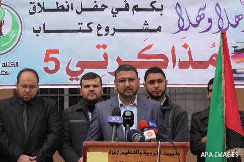Members of the Islamist bloc represented by Hamas distributes books for Palestinian students in Gaza City, on Dec. 09, 2013. Photo by Mohammed Asad
