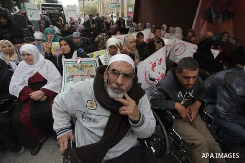 Palestinians and physically challenged people take part in a protest demanding the release of Palestinian prisoners held in Israeli jails, in front of the Red Cross office in Gaza City on Dec. 09, 2013. Photo by Ashraf A...