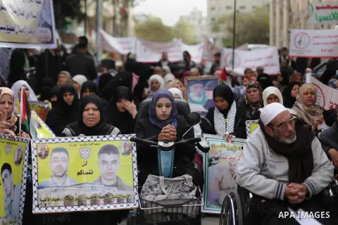 Palestinians and physically challenged people take part in a protest demanding the release of Palestinian prisoners held in Israeli jails, in front of the Red Cross office in Gaza City on Dec. 09, 2013. Photo by Ashraf A...