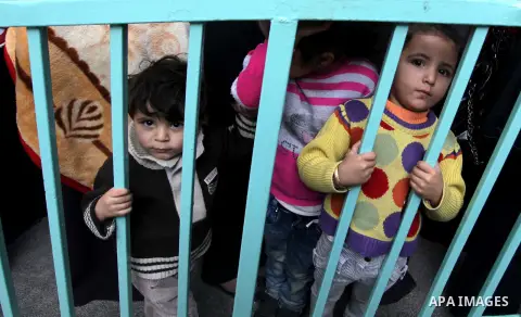 Palestinian children wait in line to receive polio-vaccine during five days of an anti-polio campaign, in Gaza City on December 09, 2013. The Minister of Health in Gaza Strip, Mufid al-Mokhalalaty, said on Sunday that hi...