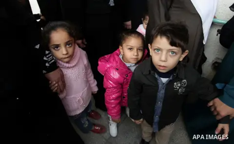 Palestinian children wait in line to receive polio-vaccine during five days of an anti-polio campaign, in Gaza City on December 09, 2013. The Minister of Health in Gaza Strip, Mufid al-Mokhalalaty, said on Sunday that hi...