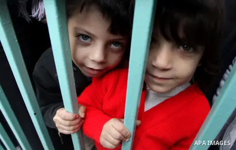 Palestinian children wait in line to receive polio-vaccine during five days of an anti-polio campaign, in Gaza City on December 09, 2013. The Minister of Health in Gaza Strip, Mufid al-Mokhalalaty, said on Sunday that hi...