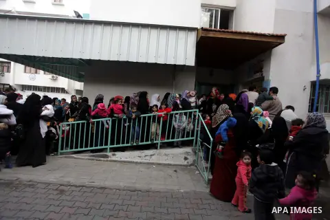 Palestinians wait in line to receive polio-vaccine during five days of an anti-polio campaign, in Gaza City on December 09, 2013. The Minister of Health in Gaza Strip, Mufid al-Mokhalalaty, said on Sunday that his minist...
