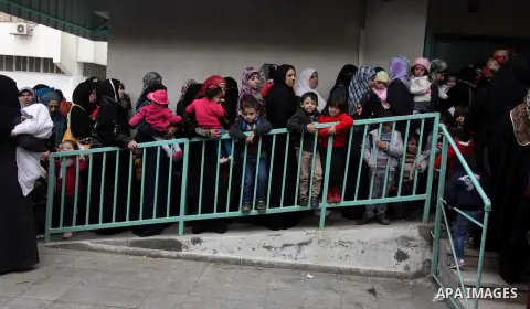 Palestinians wait in line to receive polio-vaccine during five days of an anti-polio campaign, in Gaza City on December 09, 2013. The Minister of Health in Gaza Strip, Mufid al-Mokhalalaty, said on Sunday that his minist...