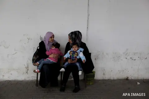 Palestinian women wait to receive polio-vaccine during five days of an anti-polio campaign, in Gaza City on December 09, 2013. The Minister of Health in Gaza Strip, Mufid al-Mokhalalaty, said on Sunday that his ministry...