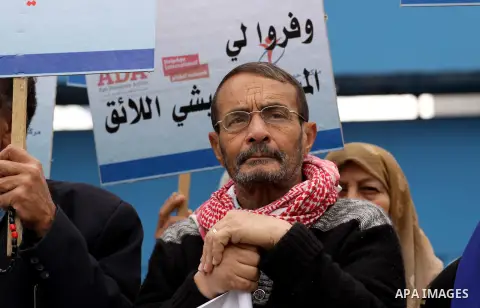 Palestinians elderly hold placards during a protest to calling the United Nations their rights on the occasion of the International Day of Human Rights in Gaza City on Dec. 10, 2013. Photo by Mohammed Asad
