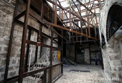 Palestinian children play at al-Qarmi neighborhood of Jerusalem's Old City, on December 10, 2013. Officials warned residents of the neighborhood to stay in their homes, that mainly cracked due to the excavations carried...