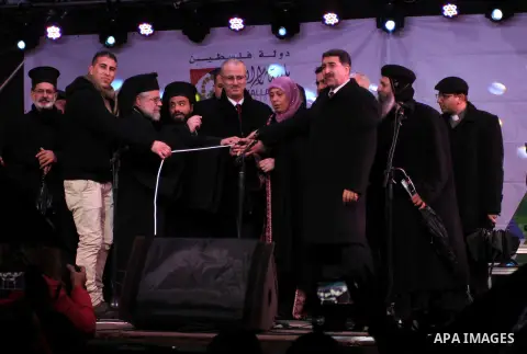 Palestinian Prime Minister Rami Hamdallah, attends the celebration of lighting the Christmas tree, in the West Bank City of Ramallah, December 10, 2013. Photo by Issam Rimawi