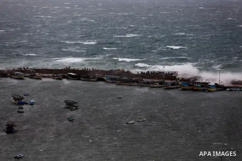 Fishing boats are seen anchored at the seaport during heavy rains on a stormy day in Gaza City, December 11, 2013. The Gaza Strip Power Authority is worried that electricity will be available for less than six hours a da...