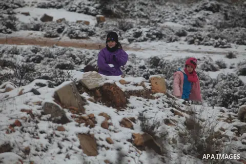 Palestinians enjoy a snowball fight during snowy weather in the West Bank city of Ramallah, 12 December 2013. The West Bank was affected by a snowstorm over the weekend, hitting Nablus, Ramallah and Jerusalem. Palestinia...